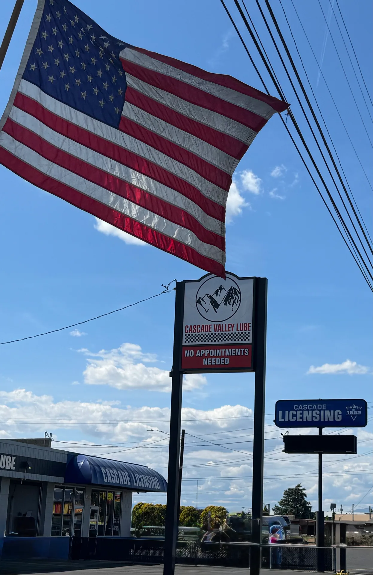 Cascade Valley Lube sign with American flag