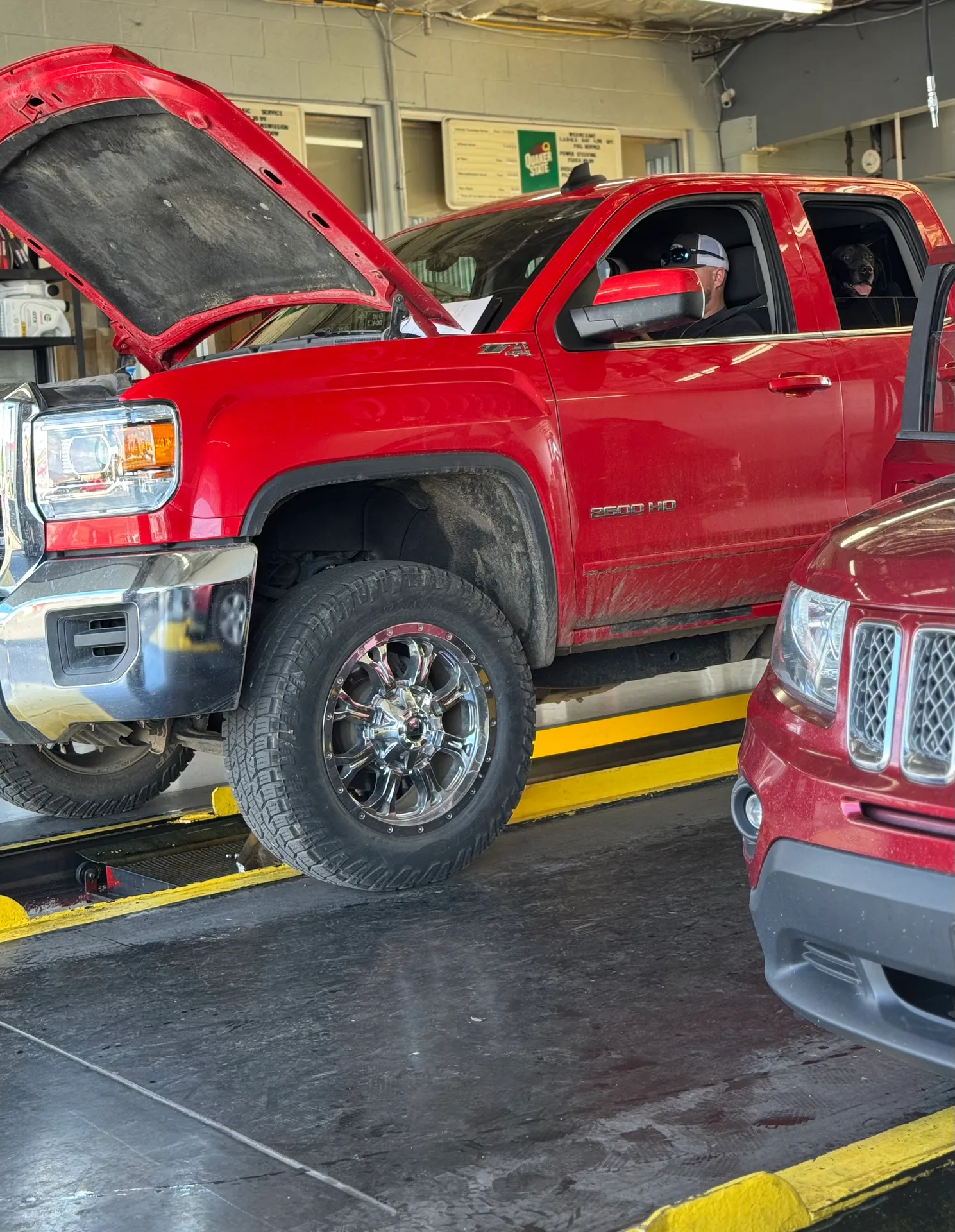 Red truck receiving service in the bay