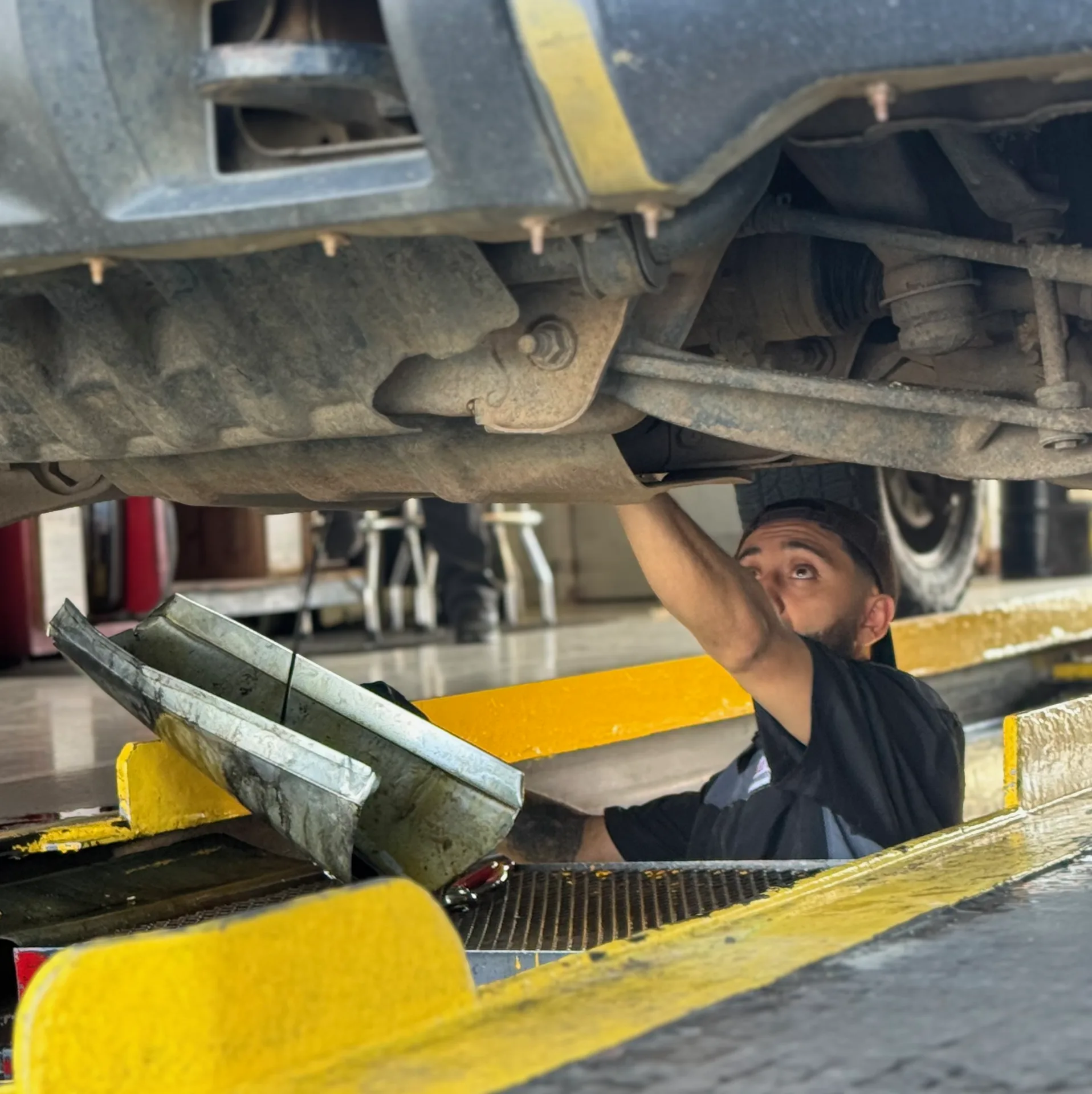 Technician working under a vehicle