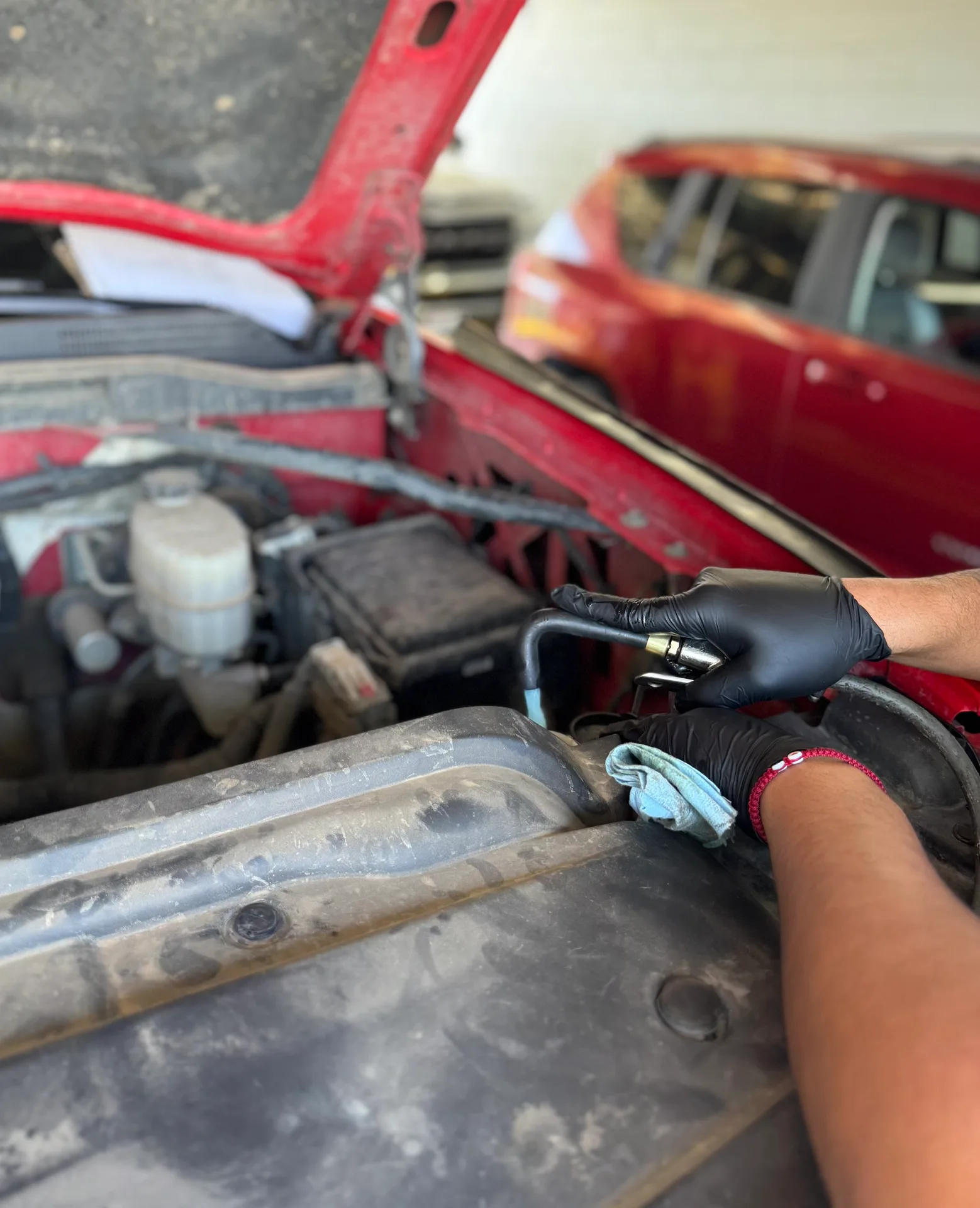 Gloved hands servicing an engine