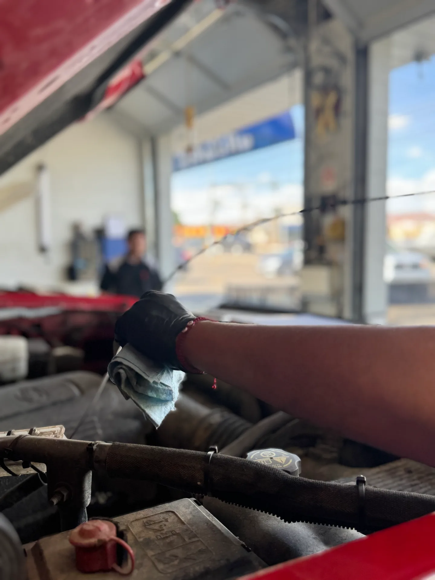 Technician working on engine fluid