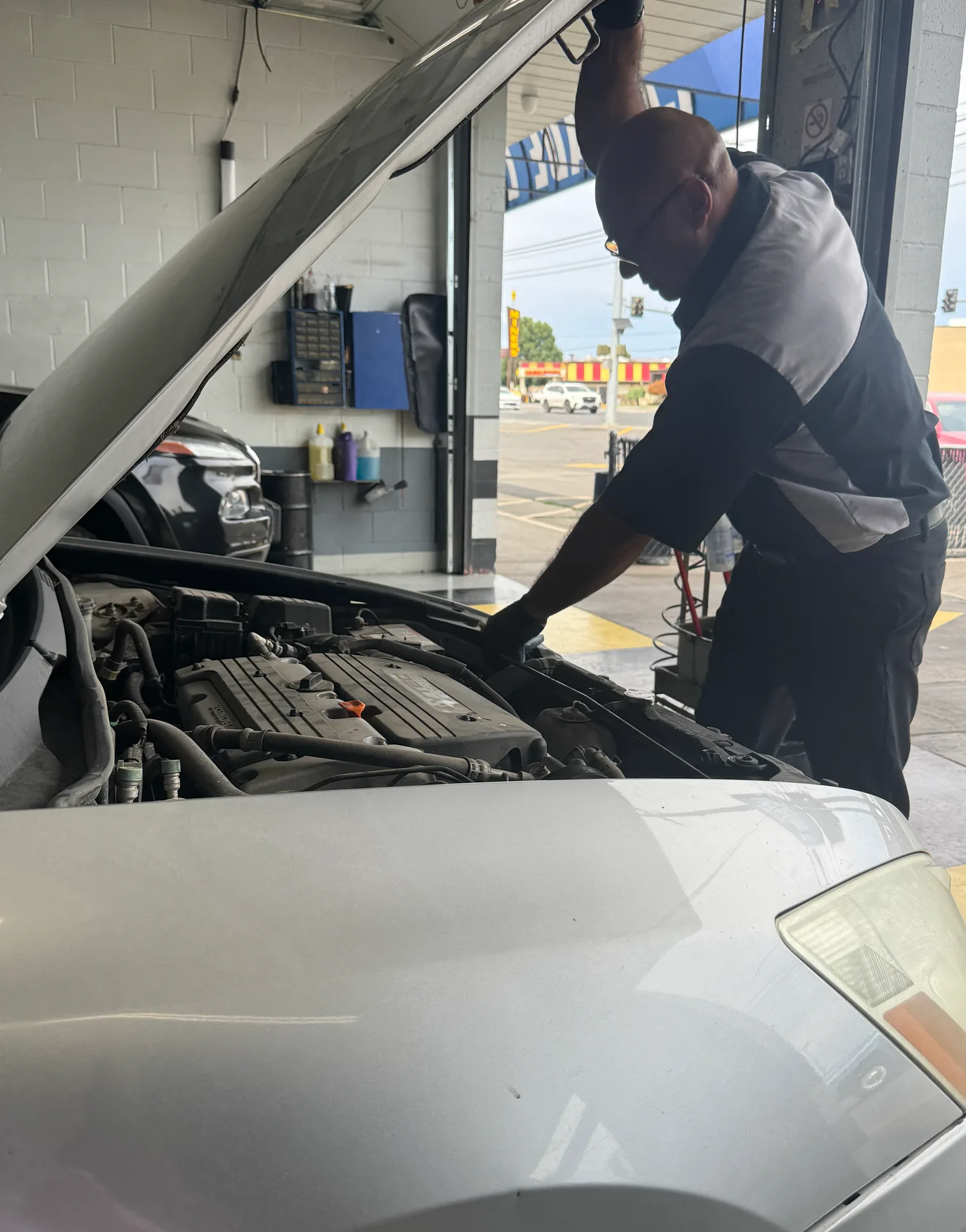 Mechanic inspecting a vehicle engine